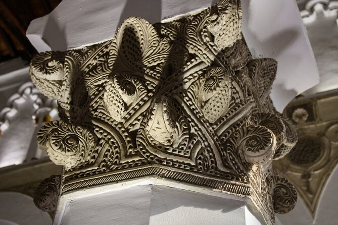 A carved plaster capital in Toledo, cut with pine-cone and scroll motifs