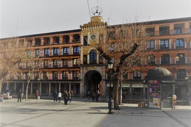 Plaza de Zocodover in Toledo, its arcaded buildings and the clock arch at one end