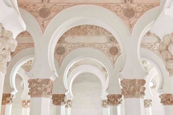 The white horseshoe arches and carved capitals inside the Synagogue of Santa María la Blanca