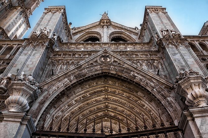 The carved Gothic arch of Toledo Cathedral's main west portal, seen from directly below