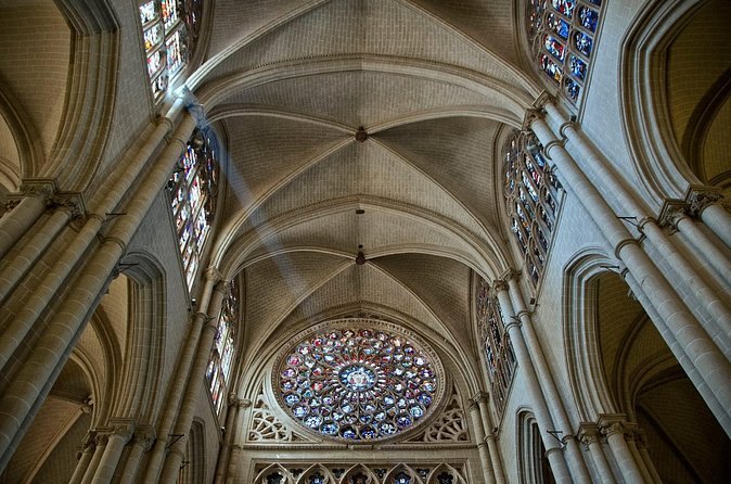 The ribbed vault and rose window of Toledo Cathedral photographed looking straight up