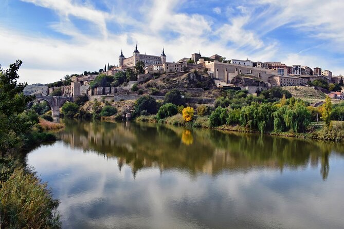 The whole hill of Toledo reflected in the still water of the Tagus, the Alcázar on the skyline